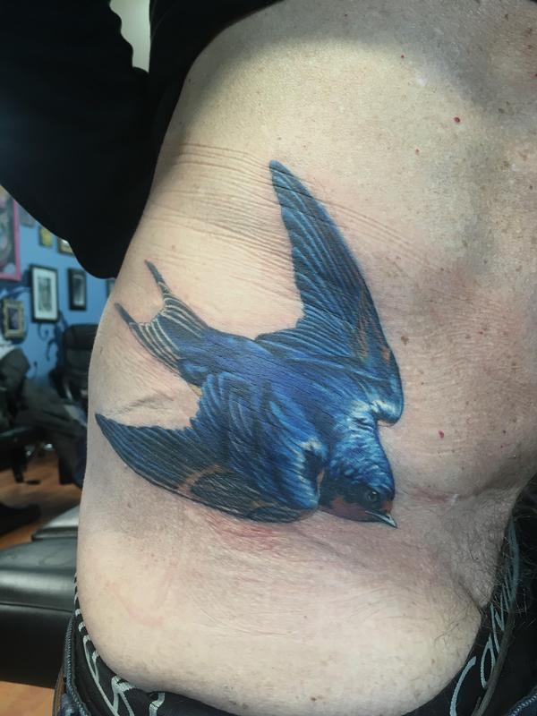 Realistic blue sparrow on hip by Rafael Marte Tattoos